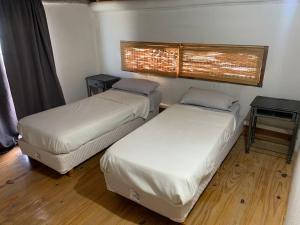 a room with two beds and a table at Don Caffe in San Pedro +15 photos