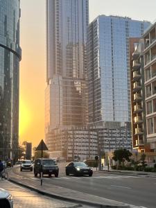 a city with cars driving down a street with tall buildings at Cozy Room In Abu Dhabi Reem island Near to Galeria Mall in Abu Dhabi