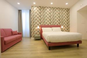 a bedroom with a bed and a couch at Elysium Relais in Naples