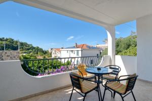 a patio with a table and chairs on a balcony at Guesthouse Drašković in Petrovac na Moru