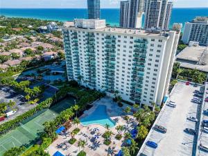 an aerial view of a large building with a tennis court at Ocean Reserve Luxury Condo Sunny Isles Beach in Sunny Isles Beach