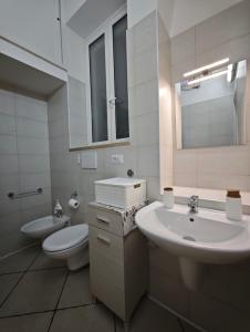 a white bathroom with a sink and a toilet at Domenico 's in Ruvo di Puglia +9 photos