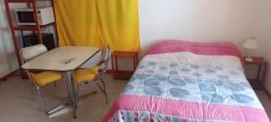 a bedroom with a bed and a desk with a computer mouse on it at Francas del Este in San Antonio Oeste