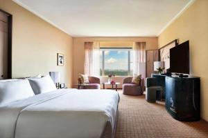 a hotel room with a bed and a living room at Hotel The Caves in New Delhi