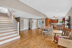 a living room with a staircase and a dining room at Secluded Woodland Retreat Near Starved Rock Park home in Grand Ridge +25 photos