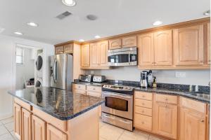 a kitchen with wooden cabinets and granite counter tops at Sea Colony - 301S Edgewater House Rd in Bethany Beach +31 photos