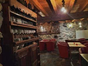 a dining room with a table and red chairs at Les Calades in Les Estables +26 photos