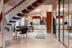 a kitchen and dining room with a staircase in a house at Santa's closest neighbor in Rovaniemi