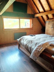 a bedroom with a bed in a wooden attic at Chalet Saint Sorlin in Saint-Sorlin-dʼArves