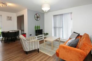 a living room with a couch and a table at Autumn Heights Apartments in Telford +60 photos
