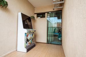 an entrance to a building with a fish tank next to a door at Casa em Jacuma, com piscina, 5 suites e fliperama in Jacumã