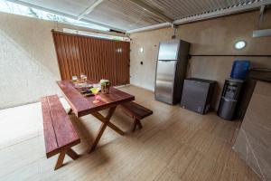 a small room with a table and a refrigerator at Casa em Jacuma, com piscina, 5 suites e fliperama in Jacumã