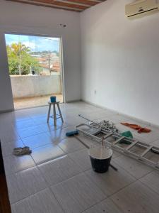 a room with a bed and a table and a window at Casa Praia do Gaviao in Araruama