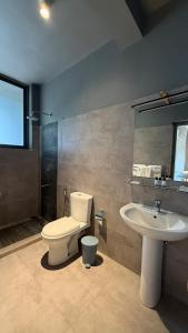 a bathroom with a toilet and a sink at Mapakada Village - Mahiyanganaya in Mahiyangana +61 photos
