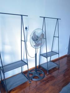 a desk with a fan next to two chairs at Jo-Anne Villa #Jeffreys Bay in Jeffreys Bay