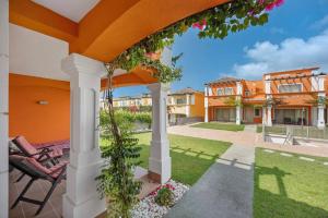 een terras met een stoel en een tuin met huizen bij Orange Lux Villa 3I in Luz de Tavira