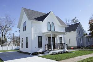 a white house with a black roof at Eliza Gothic in Maquoketa