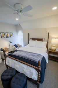 a bedroom with a large bed and a ceiling fan at Eliza Gothic in Maquoketa