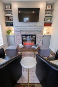 a waiting room with a fireplace and a flat screen tv at Eliza Gothic in Maquoketa