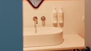 a bathroom sink with two faucets on a counter at Casa Clarita in Valencia +29 photos