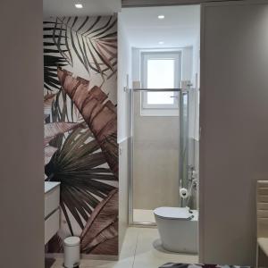 a bathroom with a shower and a toilet with a mural at RESIDENZA CORSO DALMAZIA in Civitanova Marche +16 photos