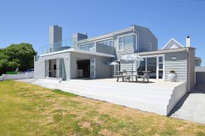 アイゼルフォンテンにあるBella Vista Yzerfontein - No loadshedding - Home away from homeのテーブル付きのデッキのある家