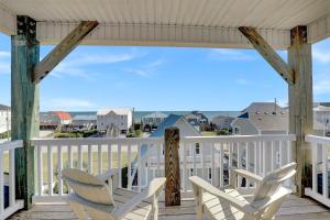 a porch with chairs and a view of the ocean at Walk to everything, 360 views, elevator, fence in Surf City +29 photos