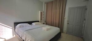a bedroom with a bed with two towels on it at Nong Lom Grand in Loei