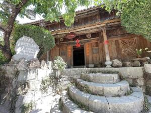 a building with stairs in front of a building at Thac so 6 homestay in Ha Giang