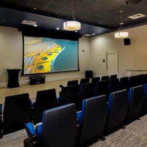 a conference room with chairs and a projection screen at Oasis in the heart of Fort Myers in Fort Myers +22 photos