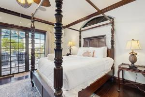 a bedroom with a four poster bed and a window at Key Quest in Marathon +32 photos