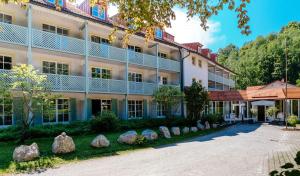 a large building with rocks in front of it at ciao-aschau Haus zur Burg Apn220 Mina in Aschau