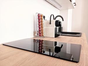 a toaster sitting on a counter next to a kitchen at Stelina Haussmann - Balcony in Villeneuve-sur-Lot +10 photos