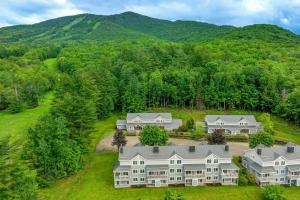 an aerial view of a house with mountains in the background at Burke Mountain Vacation Rental Ski-InandSki-Out! in East Burke