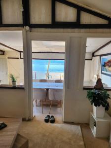 a room with a table and a view of the ocean at guyville house in Temara +8 photos