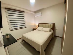 a small bedroom with a bed and a window at Beautiful apartment with a beautiful view in Equipetrol in Santa Cruz de la Sierra