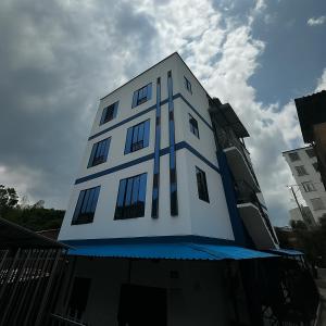 a tall white building with windows on top of it at 302 Villamaria in Pereira