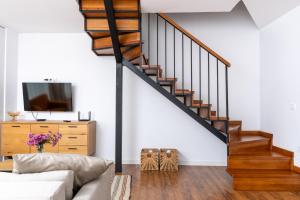 a living room with a couch and a staircase at Apart house EMA 4 in Bansko