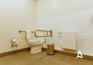 a bathroom with a toilet and a radiator at Almasur Express Punta Arenas in Punta Arenas +36 photos