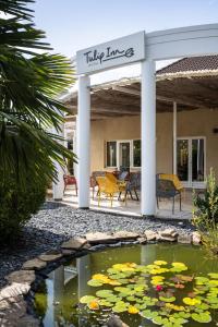 a koi pond in front of a house at Tulip Inn Beaune in Beaune