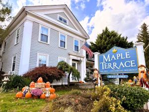 a house with a large sign in front of it at Maple Terrace Motel in Williamstown