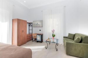 a living room with a couch and a table at Hotel Odeon Napoli in Naples