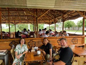 a group of people sitting at a table in a restaurant at Bill and Yen Agri Tourism Park 