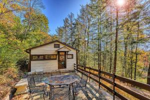 a small cabin with a table and chairs in the woods at Cabin in Nature at Cliffwood Colony in Shirley +15 photos