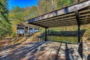 a large building with a roof with a table and chairs at Cabin in Nature at Cliffwood Colony in Shirley
