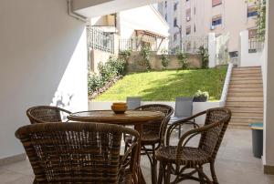 a patio with a table and chairs and stairs at Casa Viola in Reggio di Calabria