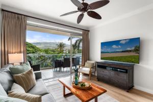 a living room with a couch and a flat screen tv at Maui Luxury Mountain-View Villa at Honua Kai in Lahaina