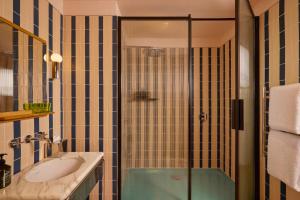 a bathroom with a glass shower and a sink at Sir Devonshire Square Hotel, part of Sircle Collection in London +62 photos
