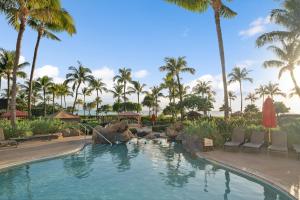 a swimming pool with a water slide in a resort at Maui Luxury Mountain-View Villa at Honua Kai in Lahaina