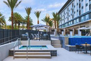 a patio with a swimming pool next to a building at AC Hotel by Marriott Las Vegas Symphony Park in Las Vegas